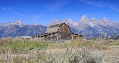 Mormon Row pioneer barn Grand Teton National Park aircraft. Pioneer settler homestead farms ranch. Historic building scenic landscape. 2.5 million visitors a year. Geography, geology, environment.