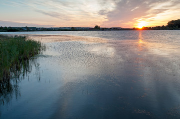 colorful sunrise on a forest lake in autumn