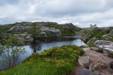 Obraz premium Mountains on the way to the Preachers Pulpit Rock in fjord Lysefjord - Norway - nature and travel background. Lake Tjodnane, july 2019