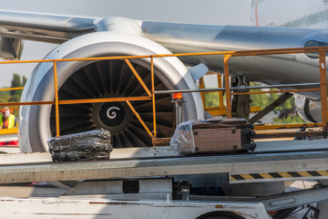 Travel bags and airplane in airport. Loading suitcases on an aircraft, preparing for flight