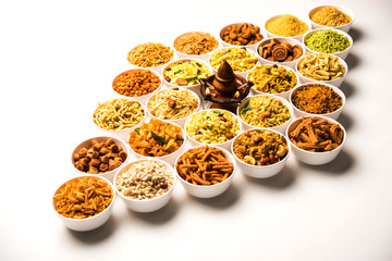 Rangoli of Farsan/snacks in bowls for Diwali with diya