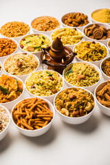 Rangoli of Farsan/snacks in bowls for Diwali with diya