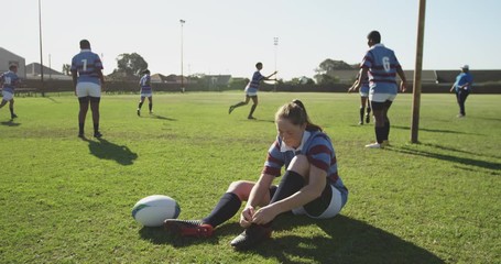 Young adult female rugby player on a rugby pitch