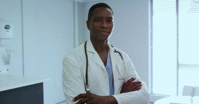 Male doctor standing with arm crossed in the hospital 