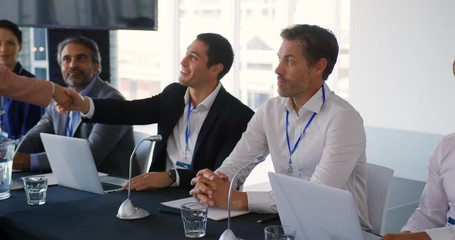 Business delegates shaking hands at a conference