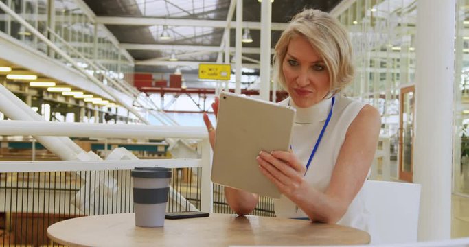 Businesswoman using a tablet in a conference foyer