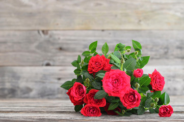 Valentines Day red roses on wooden background with copy space