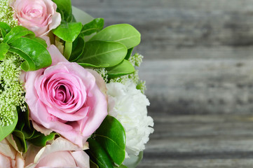 Mothers Day card with bouquet of flowers on wooden background