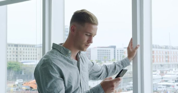 Man using smartphone in a modern office