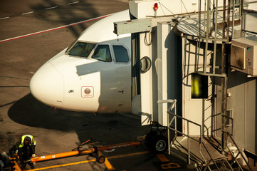 Teletrap connected to the aircraft. The telescopic ladder is connected to the aircraft. airport engineering systems work. Boarding and disembarking passengers from an airplane.