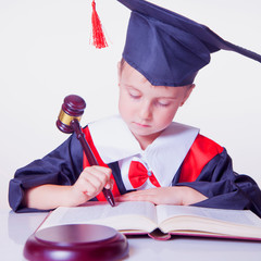 Child girl judge (lawyer) makes notes and reads Judicial Writing Manual: A Pocket Guide for Judges....