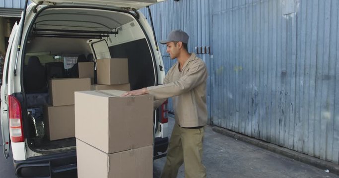 Young male van driver with a warehouse delivery