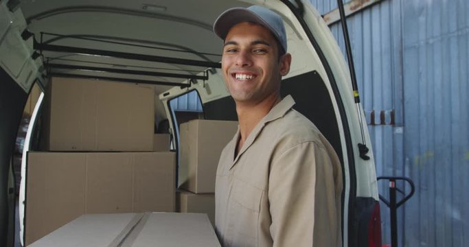 Portrait of male van driver with a warehouse delivery