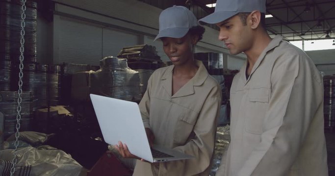 Young warehouse workers interacting