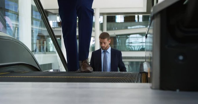 Businessman on the escalator in modern office building