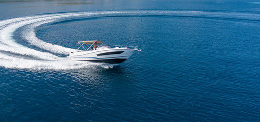 Aerial view of speed motor boat on open sea - obrazy, fototapety, plakaty