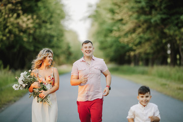 a woman looks at her husband and their son runs near