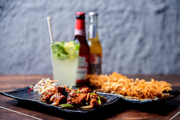 indian food thread paneer chicken tikka with beer