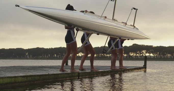 Female rowing team training on a river