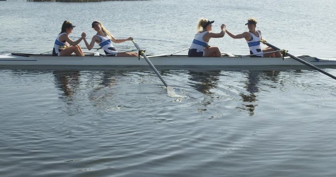 Female rowing team training on a river