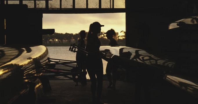 Female rowing team training on a river