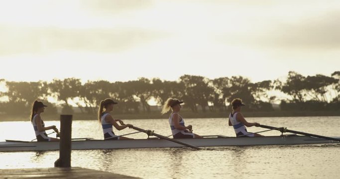 Female rowing team training on a river