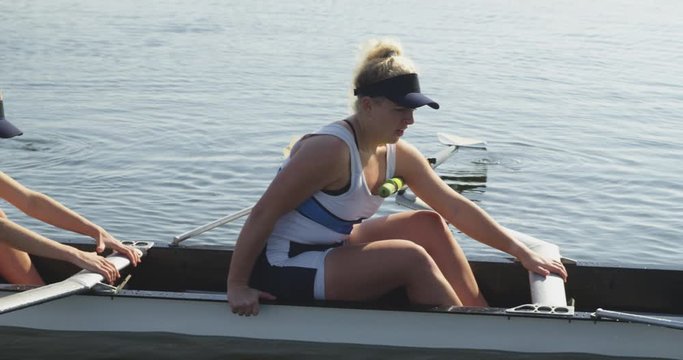 Female rowing team training on a river