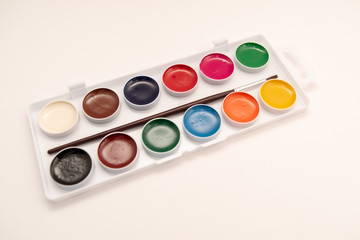 watercolor paints in box on white background