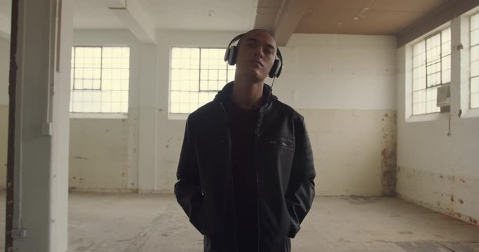 Fashionable young man in an abandoned warehouse