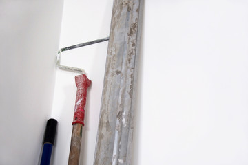 Tools for repair on white plaster wall background. Copy space