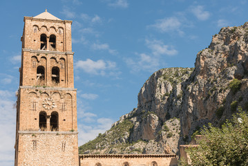 Fototapeta na wymiar Bell tower of Church of Our Lady of the Assumption at Moustiers Sainte Marie, France