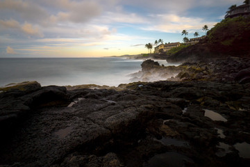 early dawn at poipu point, kauai. the low light forced a very long exposure, turning the crashing surf into a soft fog.