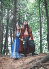 Brave Warrior Viking man with beautiful medieval woman outdoor