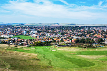 Fototapeta na wymiar View of Seaford town from cliff tops, golf course, houses on the back, selective focus