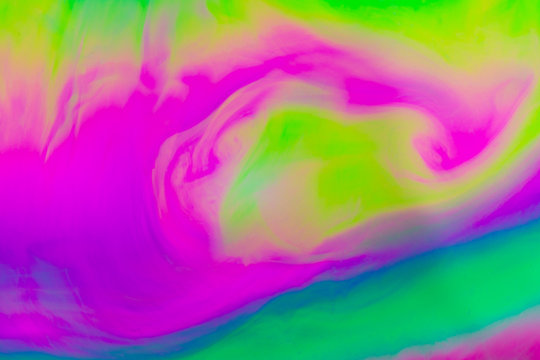 A soft smooth blur of colours giving the effect of vibrant ink or watercolour swirl background