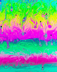A creative abstract swirling liquid rainbow of colours that looks like watercolour paints or inks that makes an interesting vibrant vivid background