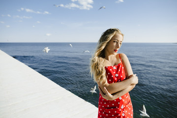 a girl with dreamy view stands on a berth