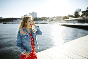a girl stands on a berth and behind her there is a sea