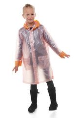 Full shot of a little blonde girl dressed in a pink nacre raincoat, black jeans, black top and black high shammy boots. The raincoat with pockets is buttoned with press-studs, 