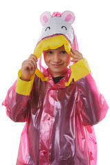 Medium close-up shot of a little girl dressed in a cherry-coloured nacre raincoat buttoned with press-studs. The hood with child cartoon picture 