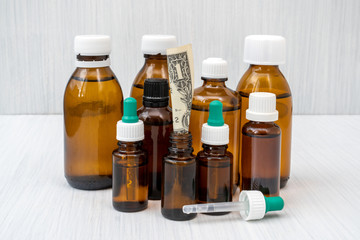 Dollar in the glass bottle with medicine