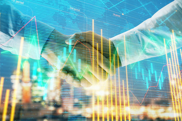 Double exposure of financial chart and world map on cityscape background with two businessmen handshake. Concept of international investment