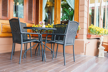 Rattan furniture table and chair in the home garden.