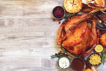Thanksgiving  feast concept with roasted Turkey gravy cranberry sauce and dinner rolls