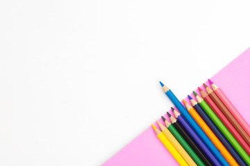 colorful pencils on green part paper on white background with copy space