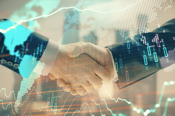 Double exposure of financial chart and world map on cityscape background with two businessmen handshake. Concept of international investment