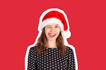 Portrait of joyful pretty woman in dress. emotional girl in santa claus christmas hat Magazine...