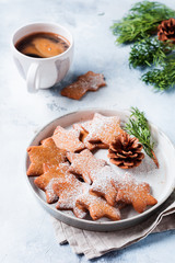 Homemade Christmas New year star shape gingerbread cookies in ceramic plate on old concrete gray vintage background. Top view with space.
