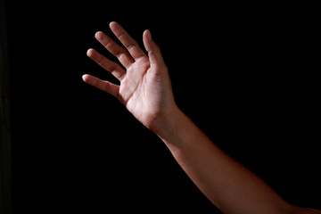 Man hands in praying position low key image. High Contrast