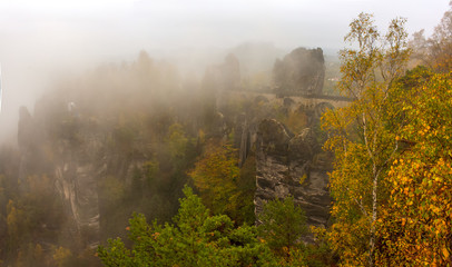 Fototapeta premium Amazing scenery of the Bastei bridge, Saxon Switzerland National Park, Germany. Autumn foggy day